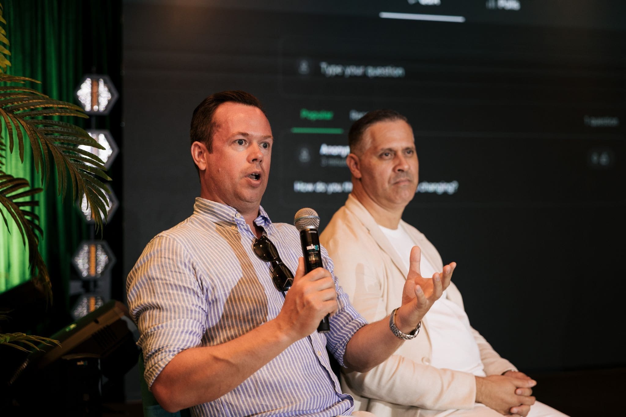 Two speakers discussing institutional finance during a B2MEET panel session.